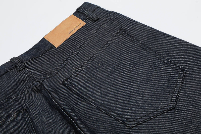 Close-up back pocket and tan waistband patch on dark wash denim jorts