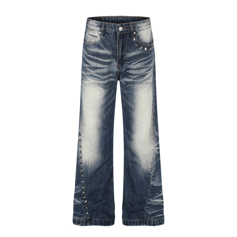 Front view of vintage wash wide-leg jeans with studded side seam and faded blue denim