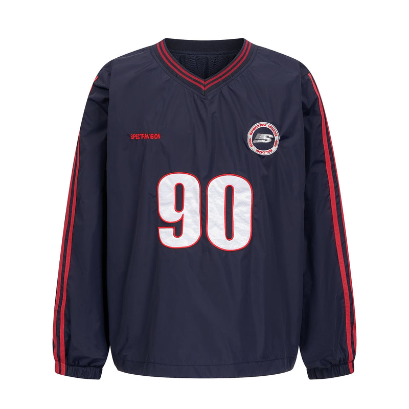 Navy nylon pullover front with white 90 graphic, red trim and chest patches