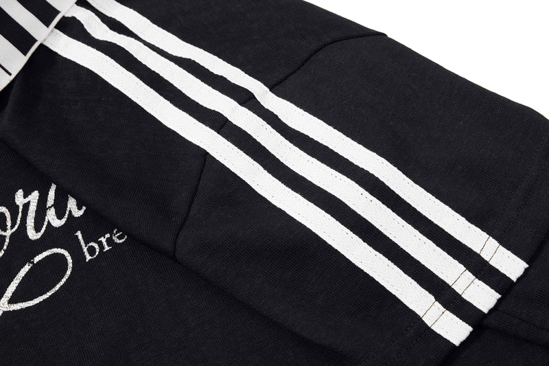 Black men's polo shirt with white striped sleeves and vintage music script graphic on the chest