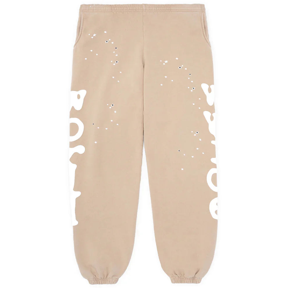 Beige 100% cotton Sp5der sweatpants for men, featuring a relaxed fit, elastic waistband and cuffs, side logo graphic, and streetwear-inspired style—perfect jogger pants for casual comfort.