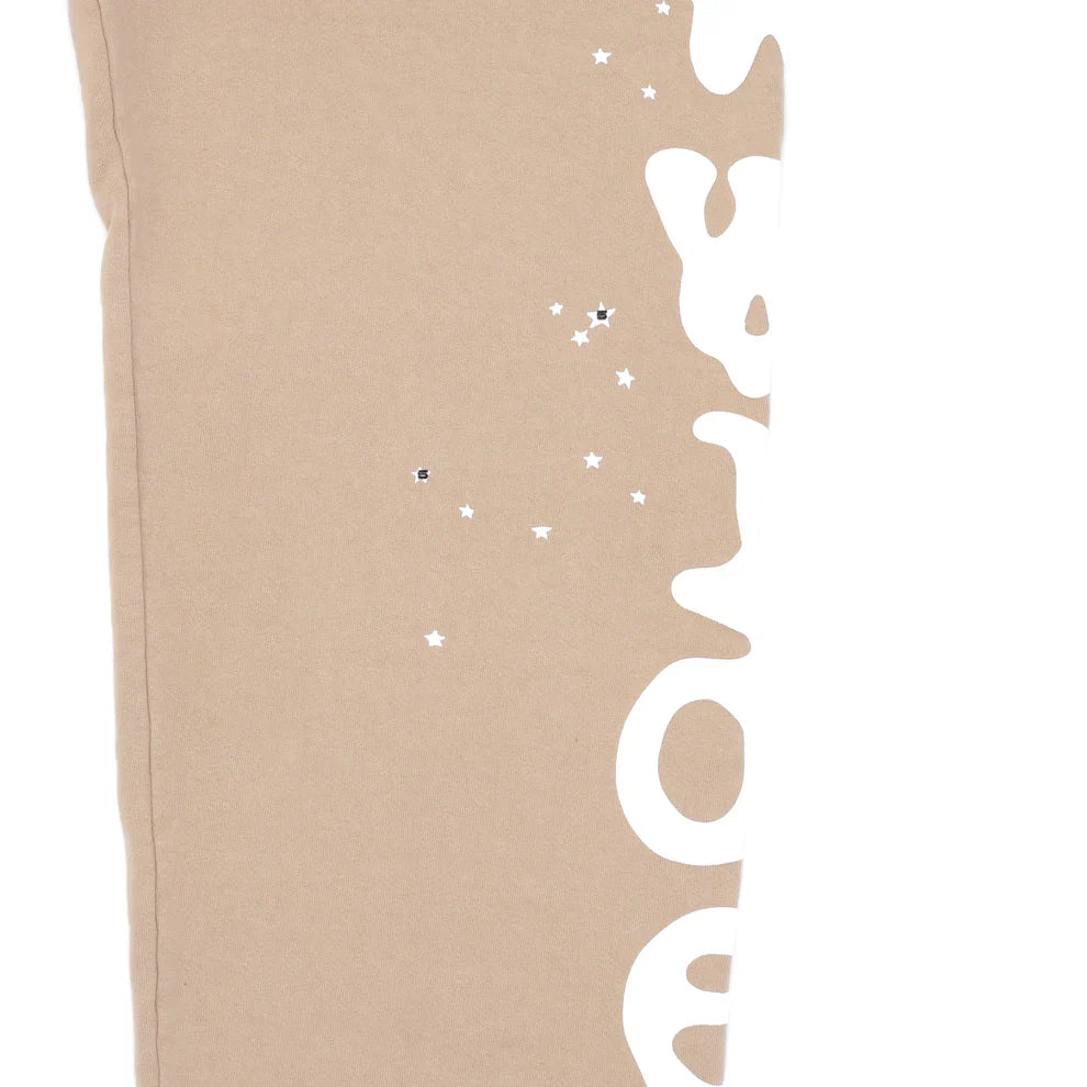 100% Cotton Sp5der Sweatpants for Men – Beige streetwear jogger pants featuring a relaxed fit and bold side logo graphic for standout style.