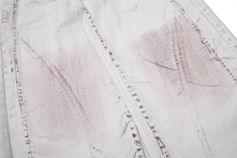 Close-up of washed denim fabric with marbled panel stitching