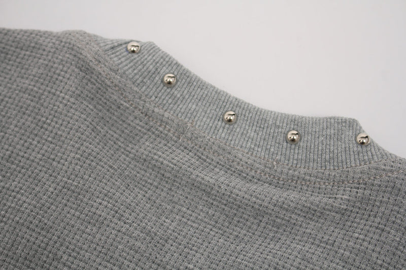Close-up of a gray waffle knit gothic tee with ribbed collar and silver studded trim details