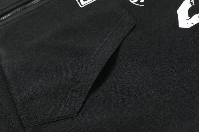 Black hoodie front pocket close-up with diagonal seam and zipper edge