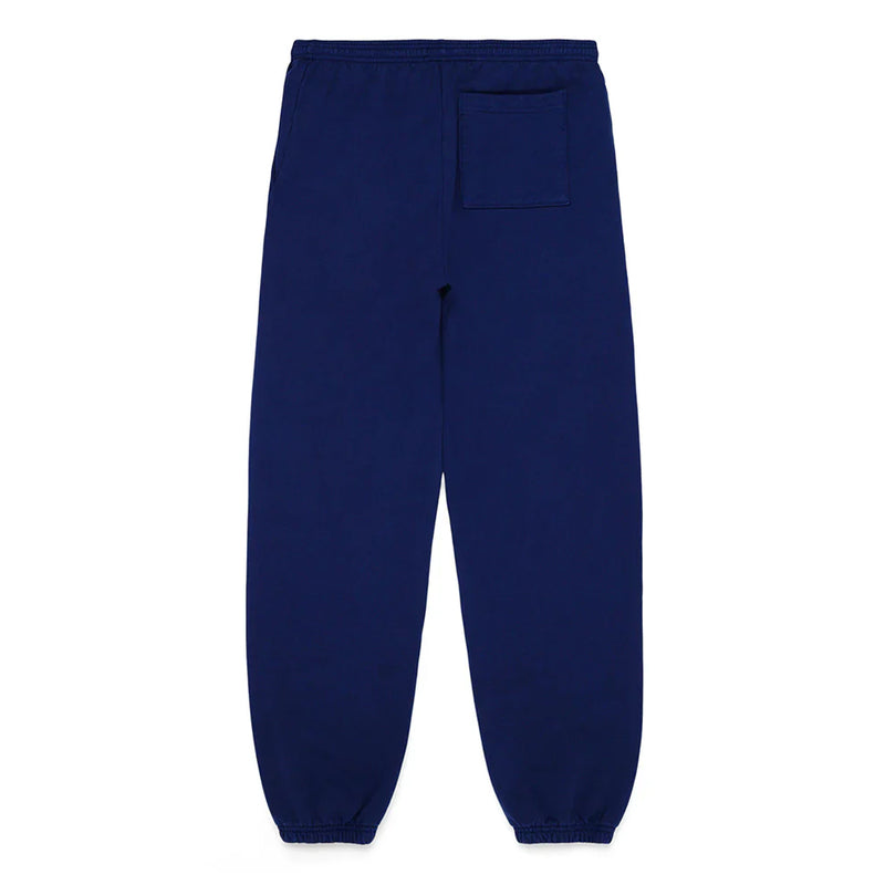 100% cotton Sp5der sweatpants in navy blue, unisex relaxed-fit jogger pants with pink logo and star graphics, featuring an elastic waistband, ankle cuffs, and a back right patch pocket—laid flat on a white background.