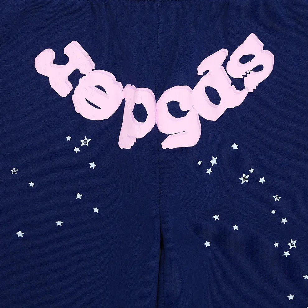 These unisex navy blue Sp5der sweatpants are made from 100% cotton, featuring a pink logo and star graphics in a relaxed fit—ideal jogger pants for streetwear style.