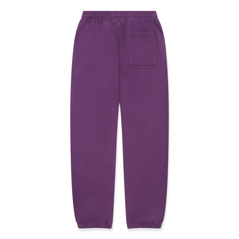 100% Cotton Sp5der Sweatpants – Unisex purple jogger pants with yellow logo and star graphics, featuring an elastic waistband, cuffs, and a single back patch pocket. Relaxed fit for simple, casual streetwear style.