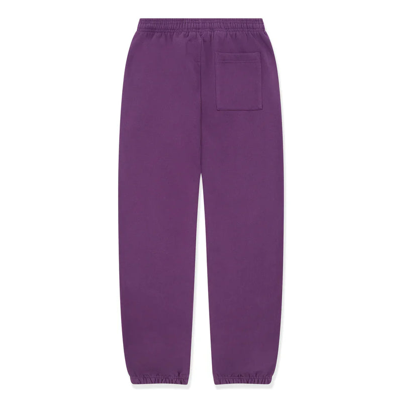 100% Cotton Sp5der Sweatpants – Unisex purple jogger pants with yellow logo and star graphics, featuring an elastic waistband, cuffs, and a single back patch pocket. Relaxed fit for simple, casual streetwear style.