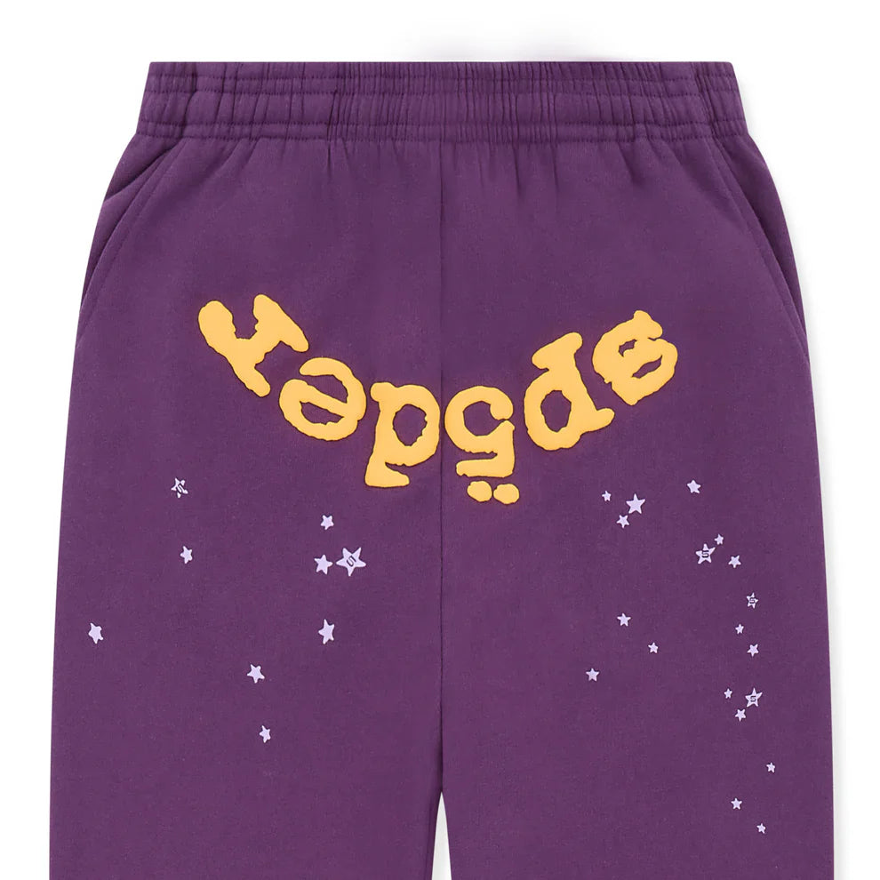 Unisex 100% cotton Sp5der sweatpants in purple, featuring a relaxed fit, elastic waistband, large yellow logo across the back, and white star graphics—stylish streetwear jogger pants inspired by Sp5der.