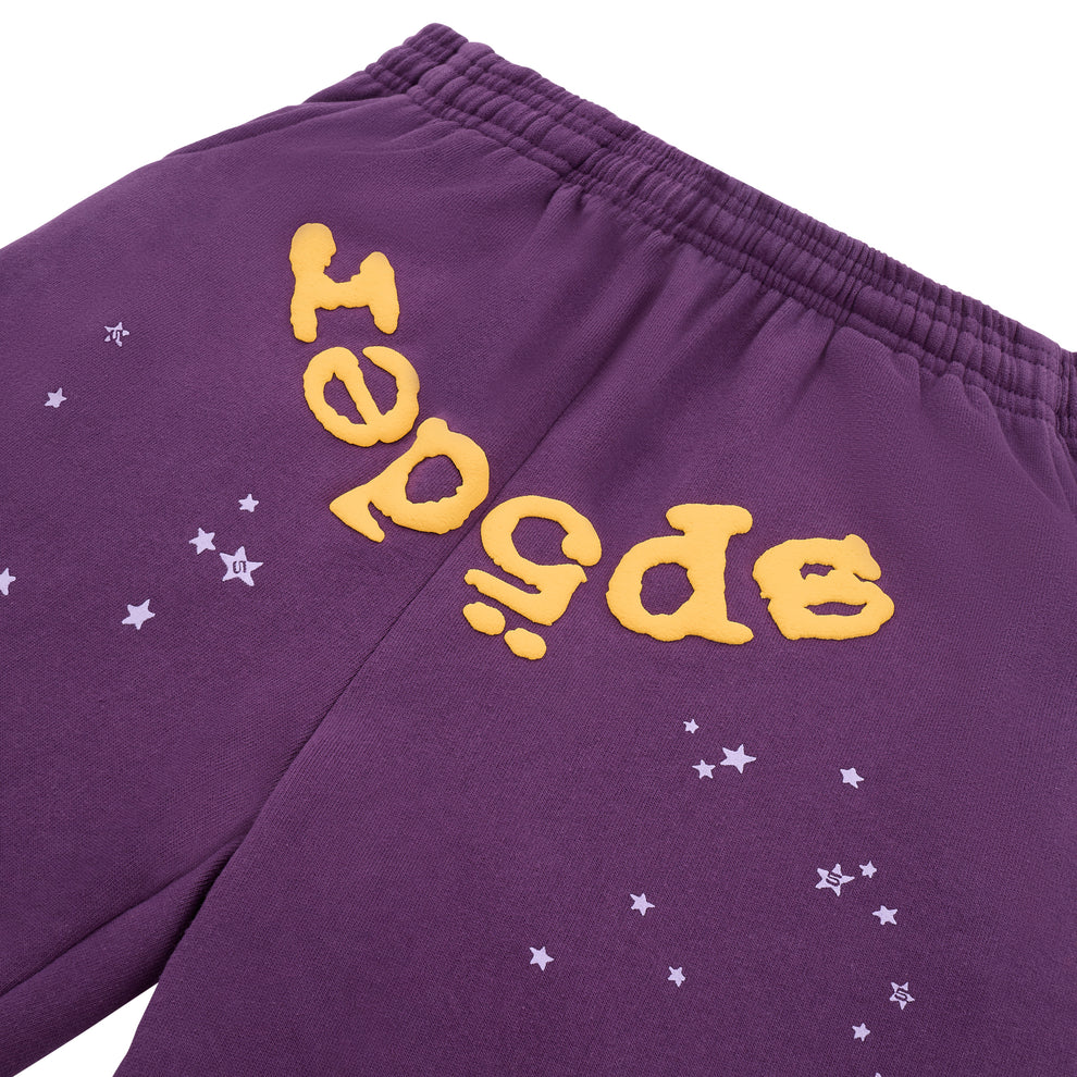Stand out in these 100% Cotton Sp5der Sweatpants—unisex purple joggers with a bold yellow logo and star graphics, featuring a relaxed fit and elastic waistband for comfortable, stylish streetwear.