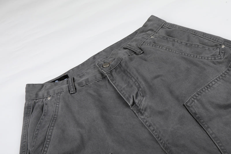 Close-up of gray cargo shorts front waistband, belt loops, and upper pockets