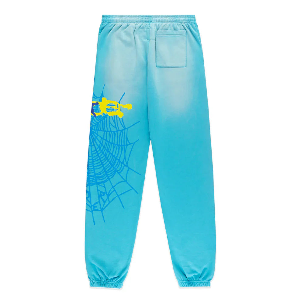 The 100% Cotton Sp5der Sweatpants are unisex blue jogger pants featuring a relaxed fit, spider web graphic with star details, elastic waistband and cuffs, plus a small back pocket.