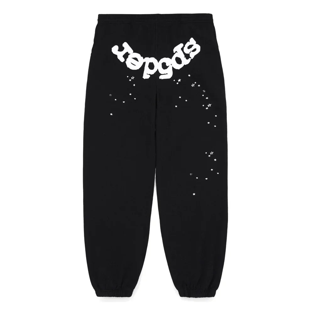 Sp5der Sweatpants – Unisex black cotton joggers with a front logo, scattered star print on the upper back legs, and elastic ankle cuffs.
