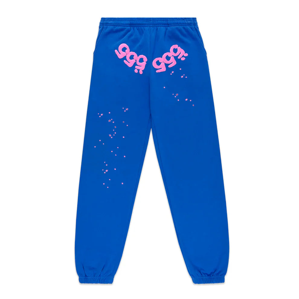 100% Cotton Sp5der Sweatpants – Unisex blue jogger pants with relaxed fit, elastic cuffs and waistband, pink logos near the pockets, and pink star accents—streetwear inspired by Sp5der style.