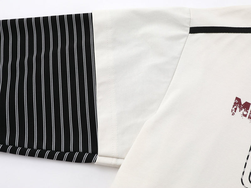 Close-up of layered sleeve and shoulder seam on cream and black striped long tee