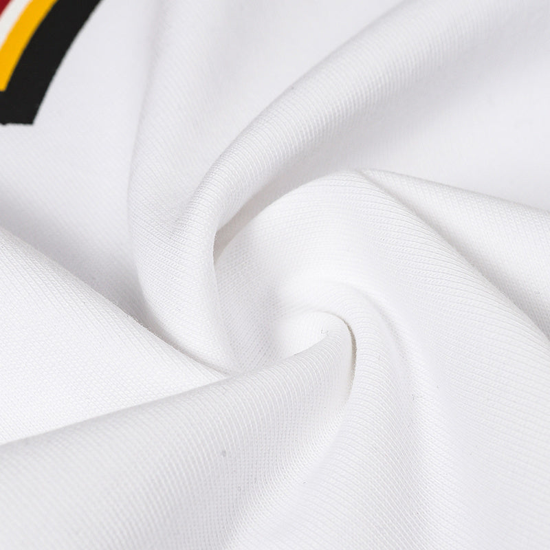 Close-up of white cotton football jersey fabric with ribbed texture and black, yellow striped detail