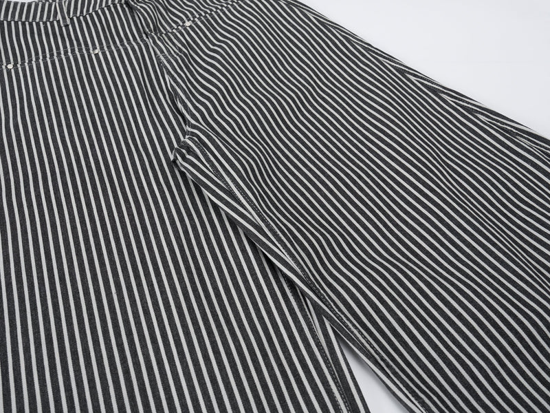 Close-up of striped jeans side panel and pocket area with vertical black and white stripes