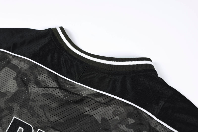 Black camo mesh football jersey with white trim and striped ribbed collar on a white background