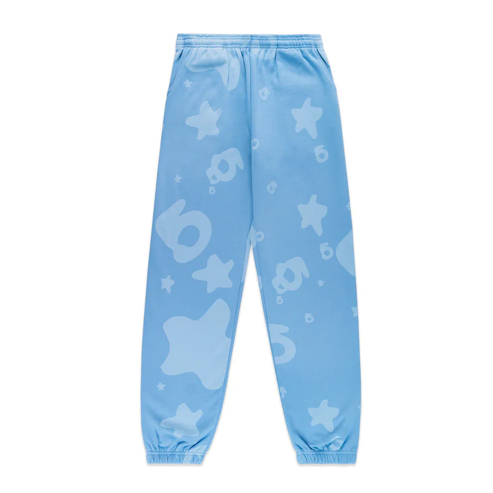 The Sp5der Light Blue All-Over Print Sweatpants are unisex streetwear joggers made from 100% cotton, featuring an elastic waistband and cuffs with a playful light blue star and bubble pattern.