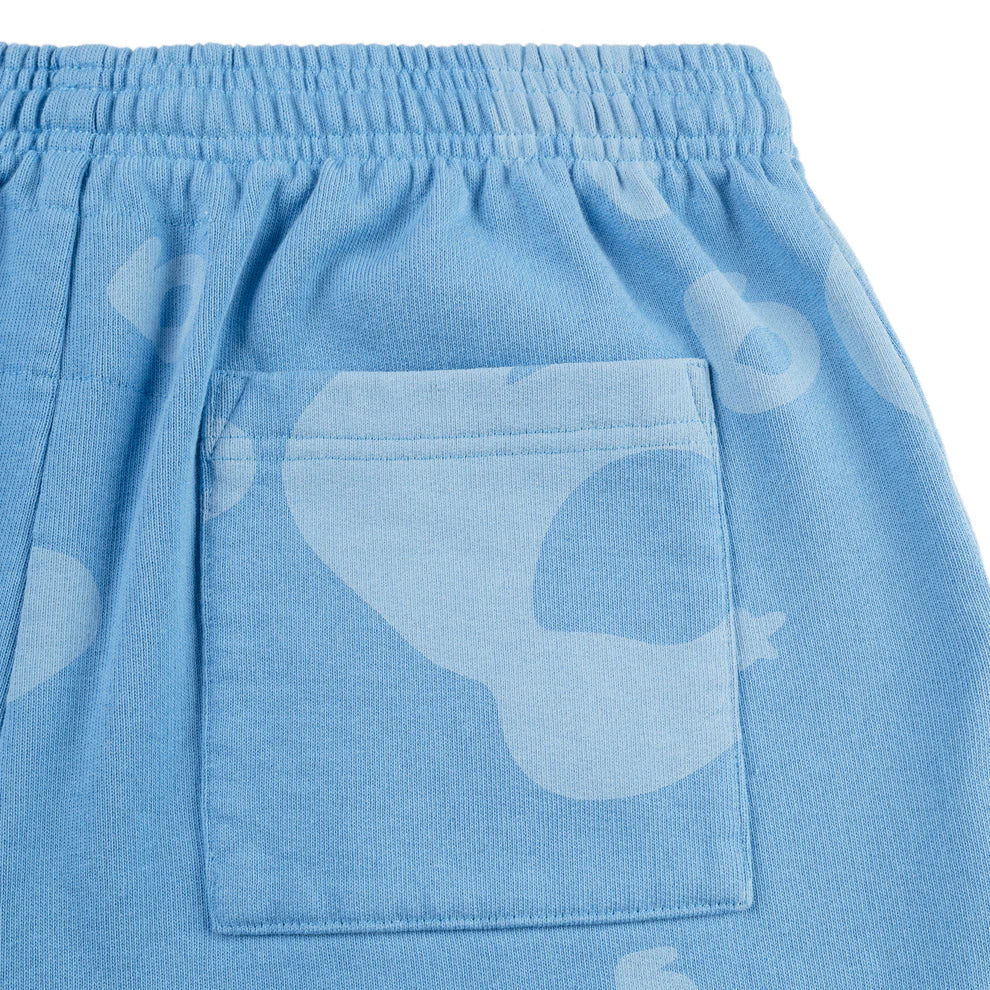 Close-up of Sp5der Light Blue All-Over Print Sweatpants, crafted from 100% cotton with an elastic waistband, square back pocket, and a subtle abstract pattern—unisex streetwear joggers for ultimate style.