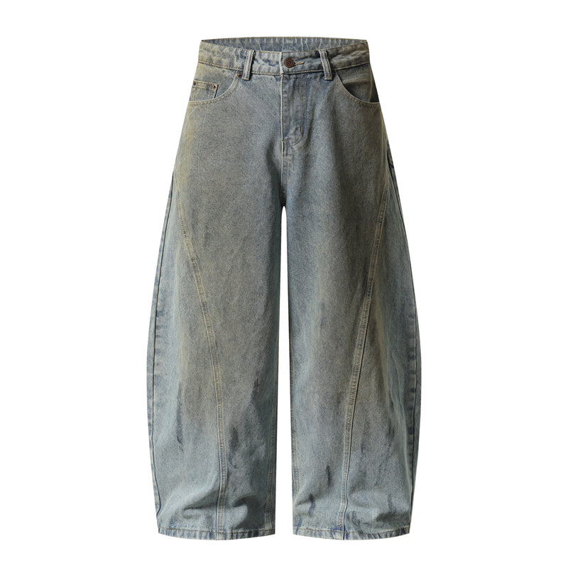 Front view of faded blue wide-leg denim pants with curved panel seams and five-pocket styling