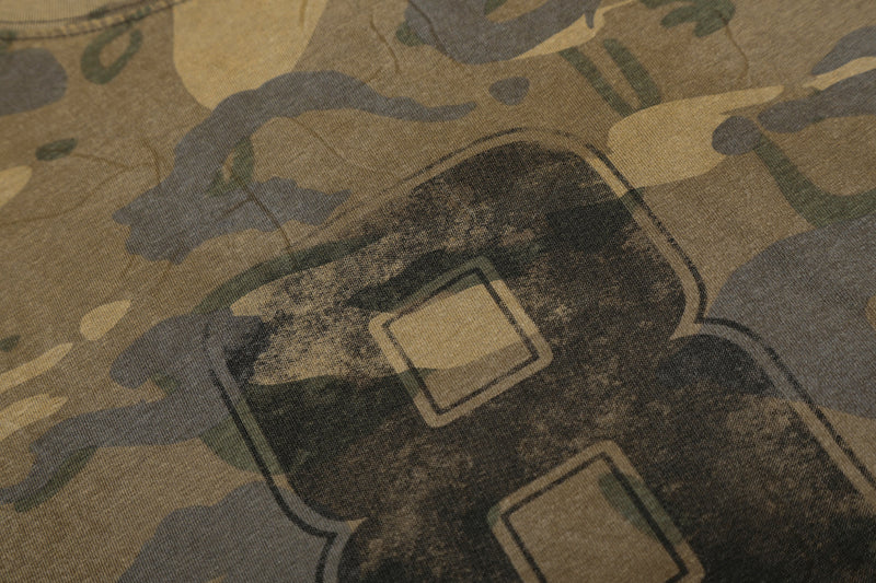 Close-up of number 8 graphic on camo long sleeve tee with faded print