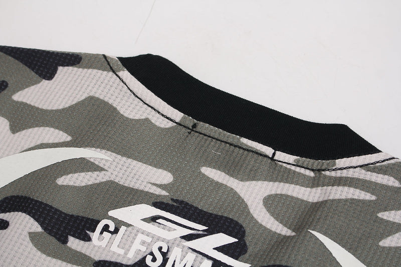 Close-up of black ribbed crew neck and camo waffle knit fabric with printed logo