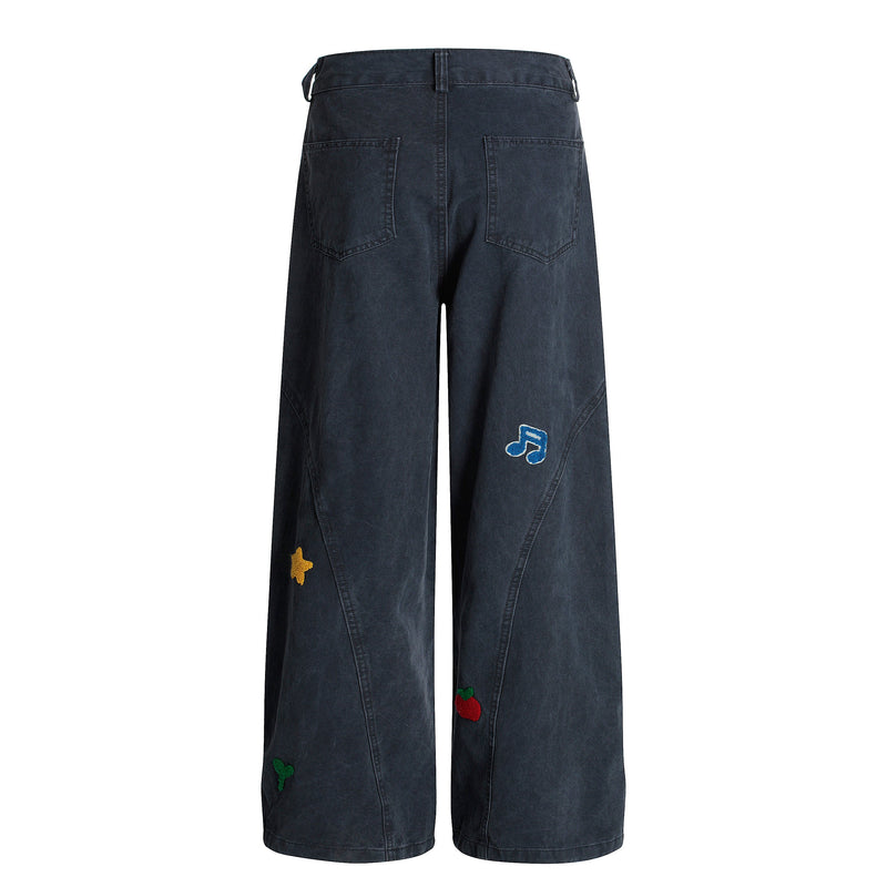 Navy wide-leg pants back view with patch pockets and blue note, star and apple embroidery