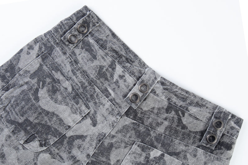 Close-up of gray distressed camo pants back pocket and waist tabs