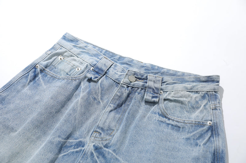 Light wash denim shorts waist close-up with button fly and rivet details