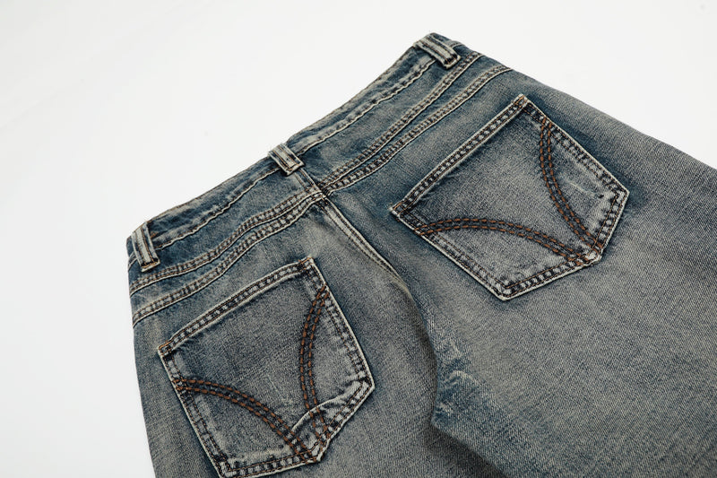 Close-up of the back waistband and pockets on vintage wash wide-leg denim jeans