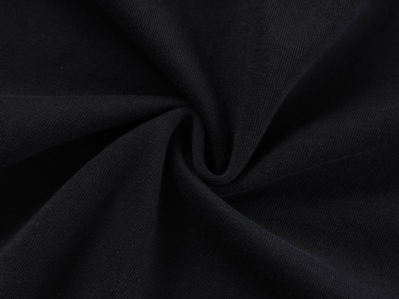 Close-up of black cotton knit fabric with soft gathered texture