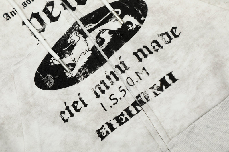 Close-up of front chest print on white hoodie with black oval graphic and gothic lettering