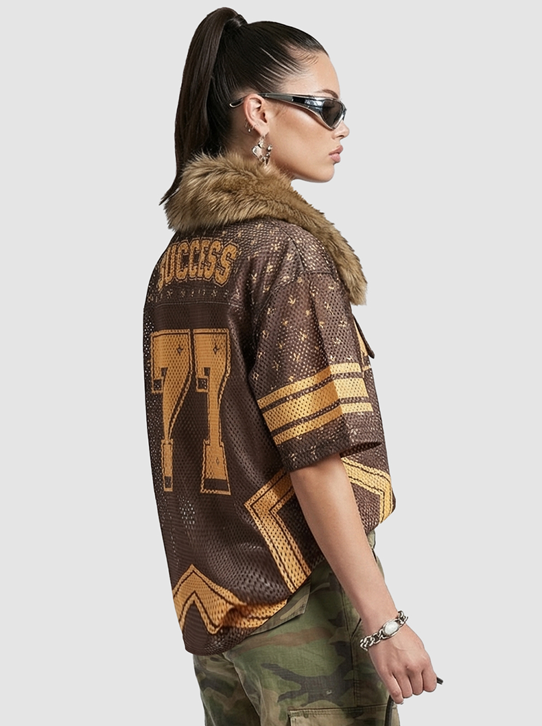 Brown and gold retro mesh jersey T-shirt with star details, number 77, and faux fur collar on a model