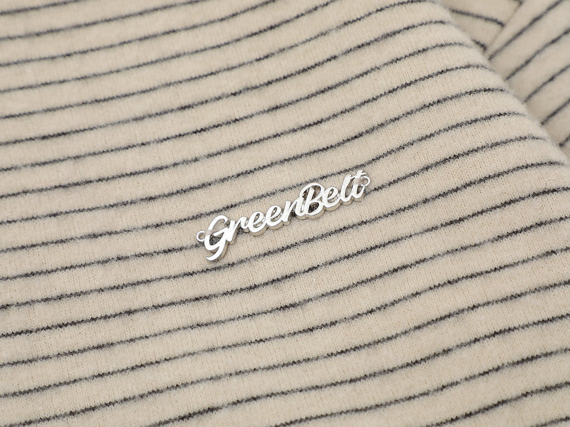 Close-up of beige striped knit fabric with GreenBelt logo applique