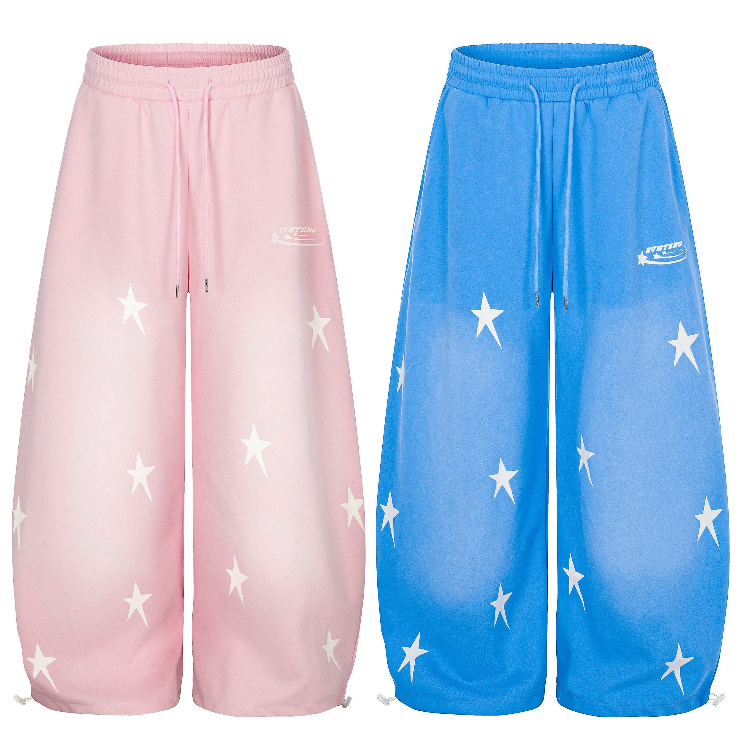 Pink and blue wide-leg sweatpants with white star print and gradient fade, shown side by side on white background