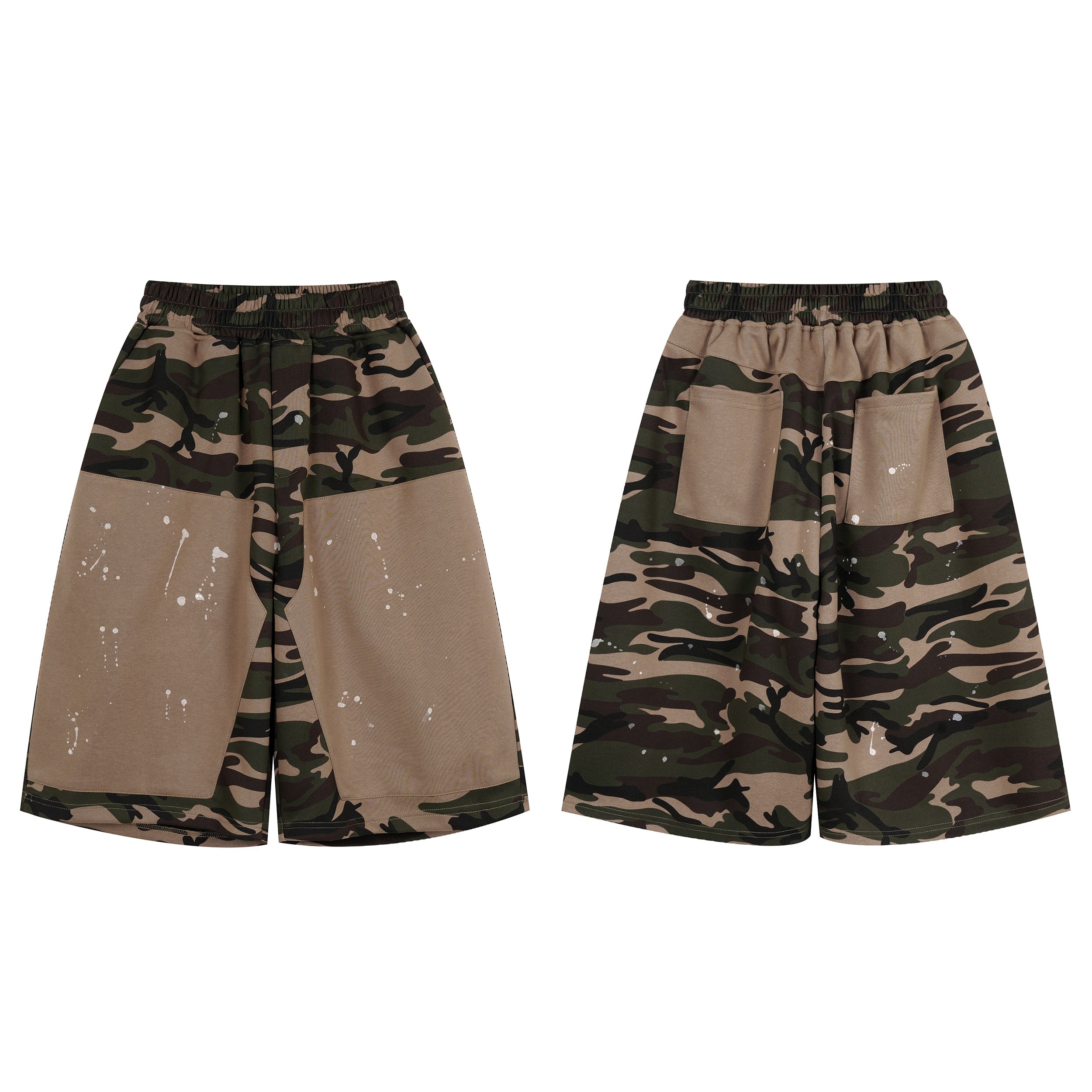 Front view of oversized camo patchwork baggy shorts with khaki contrast panels and white paint splatter detailing