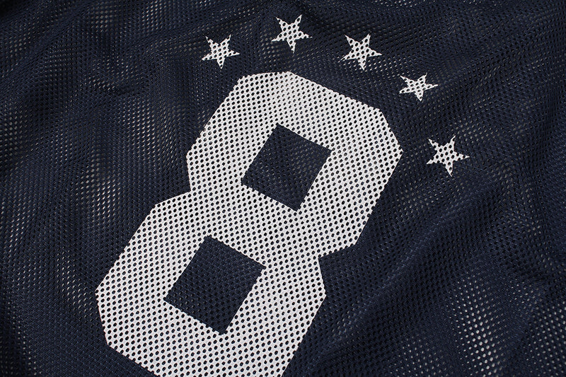 Close-up of navy mesh varsity jersey with large white number 8 and star graphics on the chest