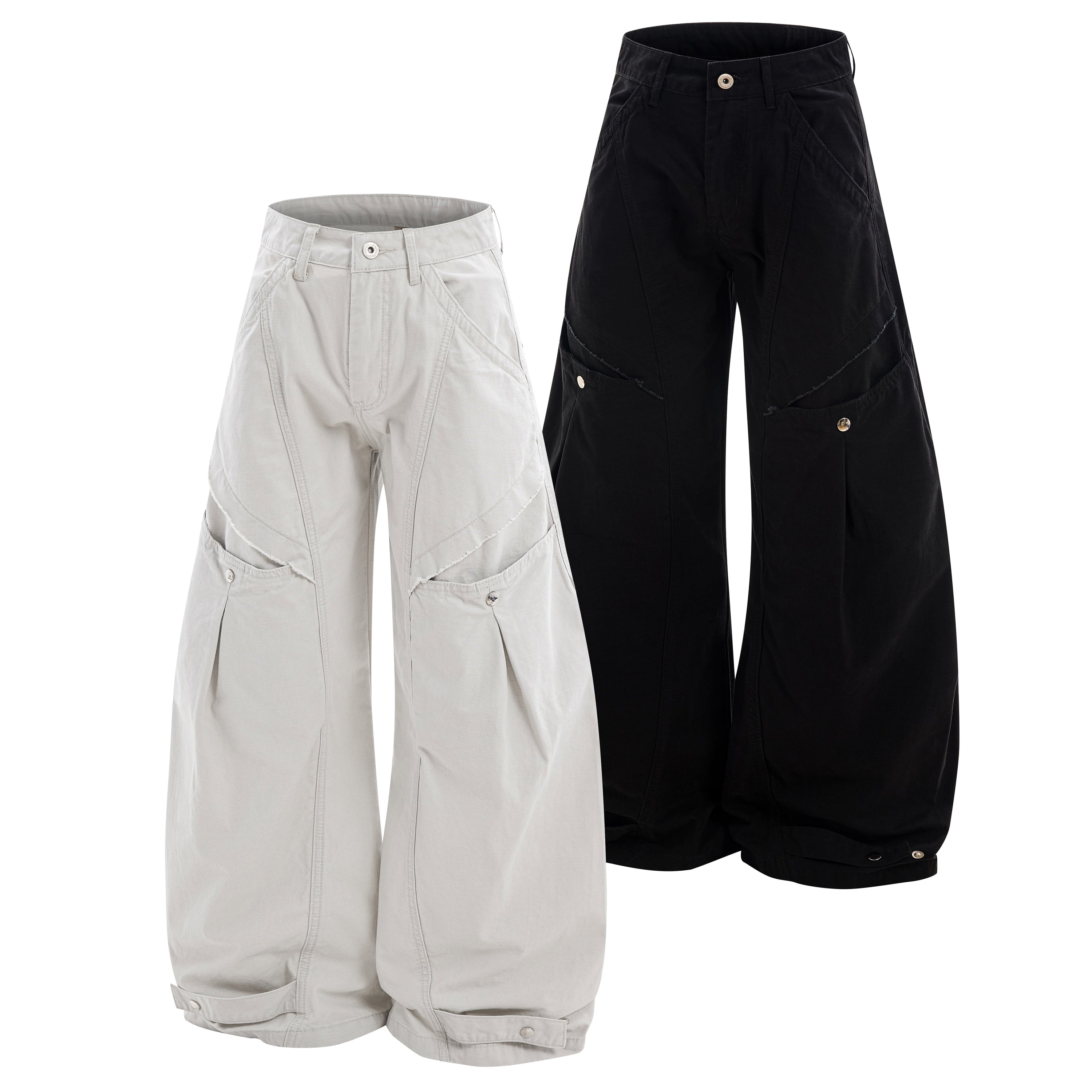 Front view of wide-leg utility cargo pants in off-white and black with curved multi-panel stitching and snap hems
