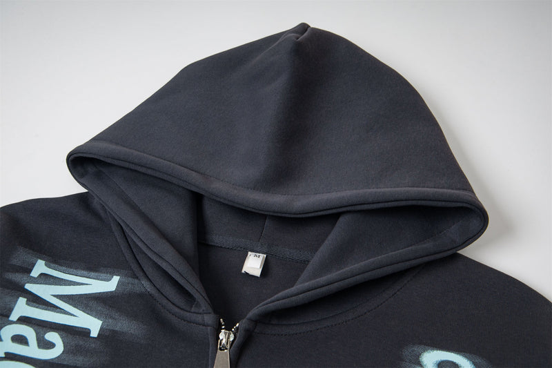 Black hooded sweatshirt close-up showing hood lining and front zipper top