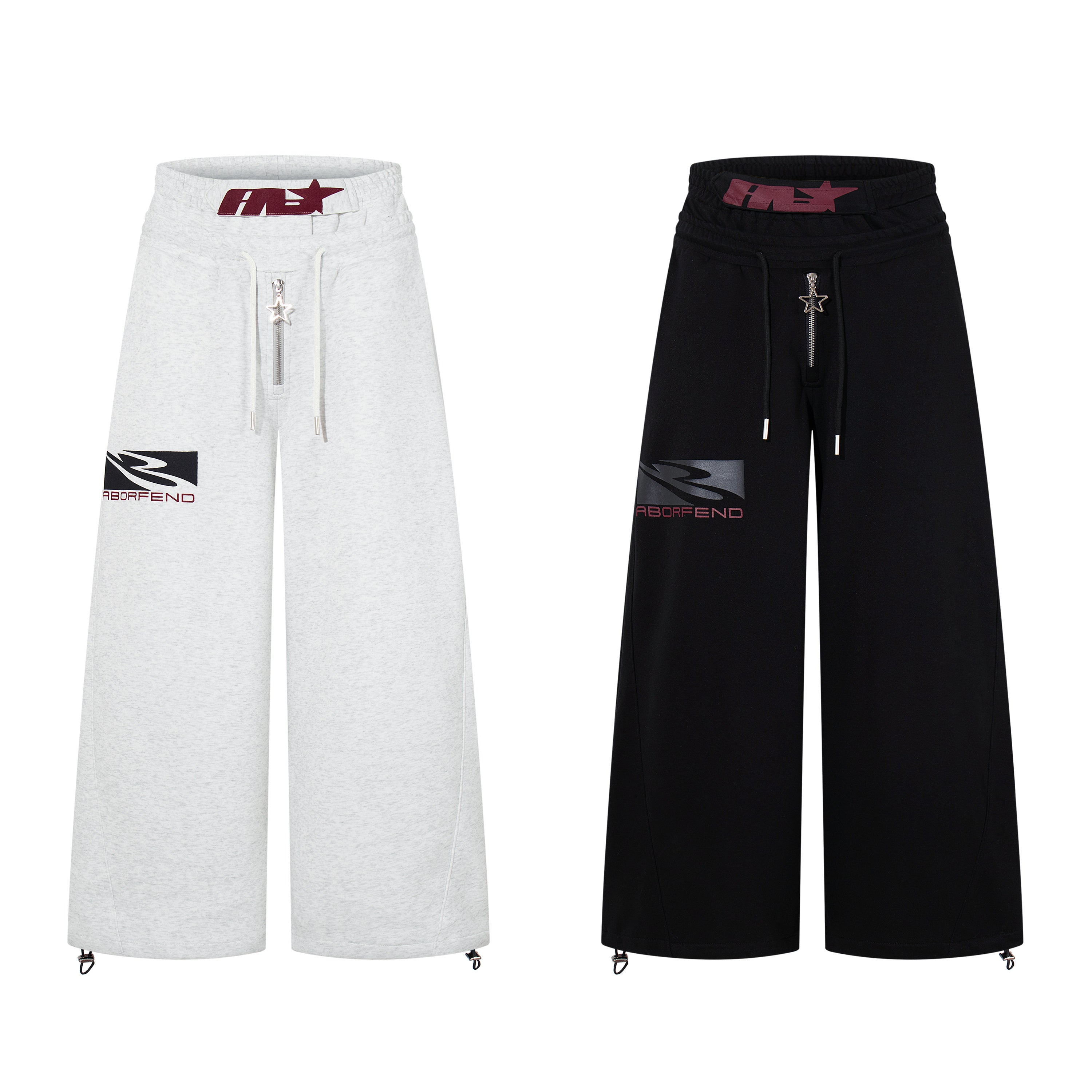 Omirad wide-leg sweatpants in light grey marl and black shown side by side, featuring star zip and logo graphic patch