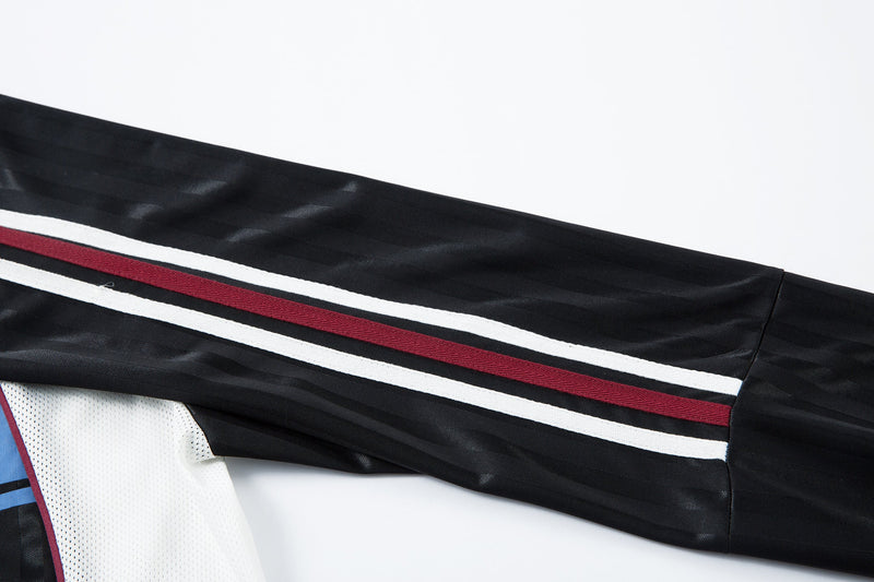 Close-up of black sleeve with white and burgundy racing stripes