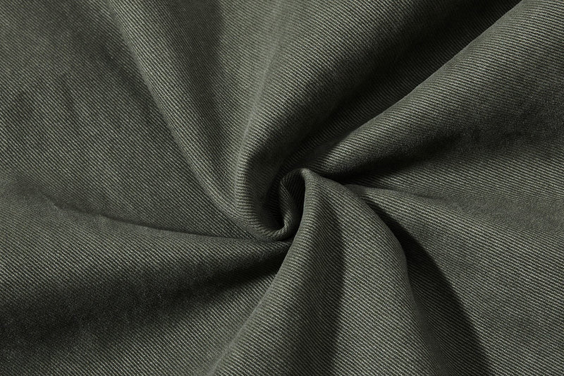Close-up of olive green fabric swirl with fine twill texture