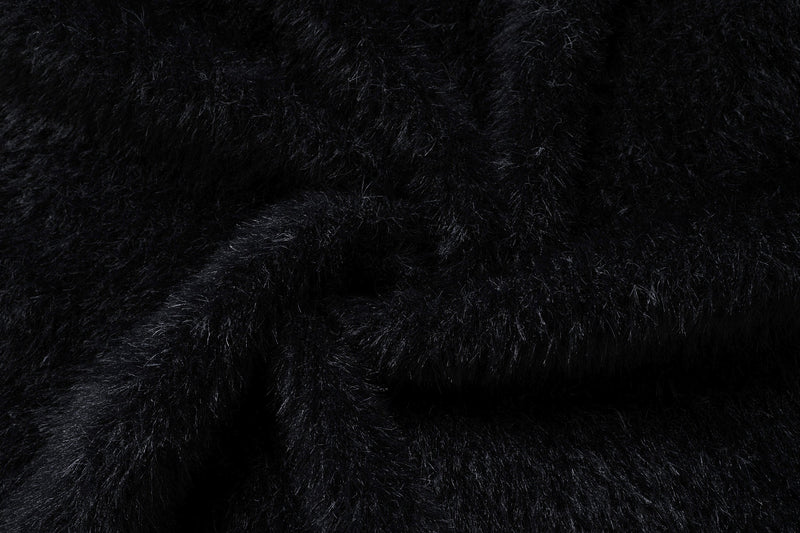 Close-up of the black sweater fabric showing dense fluffy knit texture