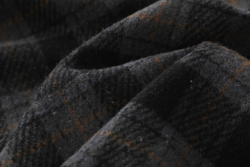 Close-up of dark plaid flannel sleeve with soft brushed texture and brown check lines