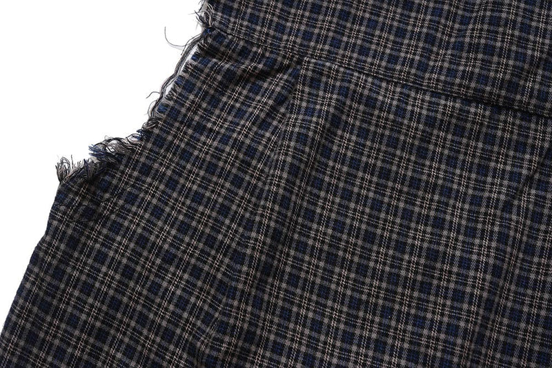 Close-up of side seam and raw-edge armhole on dark plaid shirt