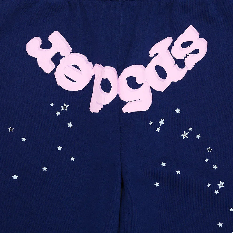 Sp5der Sweatpants – unisex navy blue cotton joggers featuring a pink front logo in bubble letters and white star print, blending unique streetwear style inspired by classic Sp5der designs.