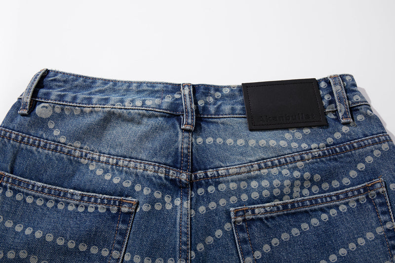 Close-up of denim waistband and back pockets with faded dot pattern and black label