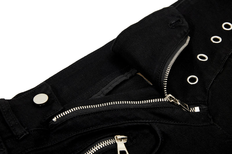 Close-up of front pocket and diagonal zipper on black pants